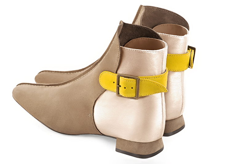 Tan beige, gold and yellow women's ankle boots with buckles at the back. Square toe. Flat flare heels. Rear view - Florence KOOIJMAN